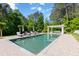 Inviting pool with sun loungers and pergola surrounded by lush landscaping in a private backyard setting at 101 Morgan Ln, Canton, GA 30115