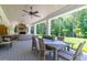 Expansive covered porch with dining and lounge areas, overlooking a lush green lawn at 101 Morgan Ln, Canton, GA 30115