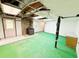 Basement features tile flooring, wood burning stove, and painted concrete walls and floor at 125 Cannongate Cir, Sharpsburg, GA 30277