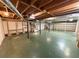 Unfinished basement with painted floor, exposed ceiling, support beams, and visible utilities at 125 Cannongate Cir, Sharpsburg, GA 30277
