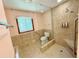 Bathroom features tile flooring, tile shower, large window, and a built-in seat in the shower at 125 Cannongate Cir, Sharpsburg, GA 30277