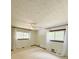 Spacious bedroom with natural light, a ceiling fan, neutral walls, and outdoor views from two windows at 125 Cannongate Cir, Sharpsburg, GA 30277