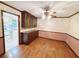 Dining room adjacent to the kitchen with hardwood floors and a chandelier at 125 Cannongate Cir, Sharpsburg, GA 30277