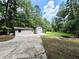 Exterior view of home featuring a large yard and driveway, a large storage garage at 125 Cannongate Cir, Sharpsburg, GA 30277