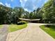 Charming home featuring a long driveway, mature trees, and well-maintained landscaping at 125 Cannongate Cir, Sharpsburg, GA 30277