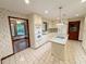 Spacious kitchen featuring an island cooktop, white cabinetry, and modern appliances at 125 Cannongate Cir, Sharpsburg, GA 30277