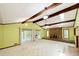Open living room with exposed beams, a brick fireplace, and sliding glass doors at 125 Cannongate Cir, Sharpsburg, GA 30277