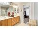 A bathroom with double sinks, a big mirror, and a doorway to the walk-in closet at 3258 Kessock Ridge Trl, Snellville, GA 30039