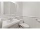 Clean and simple powder room featuring a pedestal sink, white wainscoting, and modern fixtures at 4089 Thorndale Ln # 13, Smyrna, GA 30080