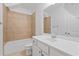 Bright bathroom showcasing a tub with tile surround and a white vanity with sink at 4089 Thorndale Ln # 13, Smyrna, GA 30080