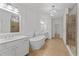 Bright bathroom featuring double sinks, soaking tub, and glass shower at 4089 Thorndale Ln # 13, Smyrna, GA 30080