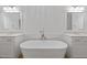 Bathroom featuring soaking tub and dual vanities with mirrors at 4089 Thorndale Ln # 13, Smyrna, GA 30080