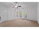 Bright bedroom with a ceiling fan, access to a balcony, and ample natural light at 4089 Thorndale Ln # 13, Smyrna, GA 30080