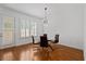 Dining room with a glass table and modern chandelier lighting, situated near doors with shutter windows at 4089 Thorndale Ln # 13, Smyrna, GA 30080