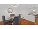 Cozy dining area with a glass table, upholstered chairs, and modern lighting, perfect for intimate gatherings at 4089 Thorndale Ln # 13, Smyrna, GA 30080