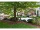 Picturesque townhome neighborhood featuring lush lawns, mature trees, and welcoming benches at 4089 Thorndale Ln # 13, Smyrna, GA 30080