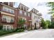 Charming townhome featuring brick and siding exteriors, multiple balconies, and meticulously landscaped front yards at 4089 Thorndale Ln # 13, Smyrna, GA 30080