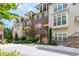 Elegant townhome with a combination of brick and siding, enhanced by stone accents and lovely landscaping at 4089 Thorndale Ln # 13, Smyrna, GA 30080