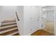 Hallway featuring hardwood stairs, a closet, and access to other rooms in the home at 4089 Thorndale Ln # 13, Smyrna, GA 30080