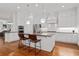 Gourmet kitchen featuring white cabinets, granite countertops, stainless steel appliances, and a center island with seating at 4089 Thorndale Ln # 13, Smyrna, GA 30080