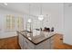 Bright kitchen featuring a granite island, stainless steel appliances, and natural light from large windows at 4089 Thorndale Ln # 13, Smyrna, GA 30080