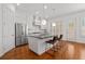 Modern kitchen with a large island, stainless steel appliances, white cabinetry, and hardwood floors at 4089 Thorndale Ln # 13, Smyrna, GA 30080