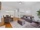 Spacious living room with hardwood floors, neutral paint, a fireplace, and an adjoining dining area at 4089 Thorndale Ln # 13, Smyrna, GA 30080