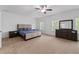 Spacious main bedroom features a ceiling fan, carpet flooring, and a large dresser at 4089 Thorndale Ln # 13, Smyrna, GA 30080