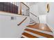 Elegant staircase with hardwood steps, white risers, and a decorative railing, offering a warm welcome at 4089 Thorndale Ln # 13, Smyrna, GA 30080