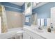 A cozy bathroom with a combination tub and shower, tiled walls, and a large mirror over the sink at 893 Piedmont Ne Ave # 5, Atlanta, GA 30309