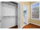 A well-organized closet that opens to the en suite bathroom with tiled floors and a window at 893 Piedmont Ne Ave # 5, Atlanta, GA 30309
