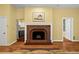 Bright living room with hardwood floors, a charming fireplace, and a glimpse into the kitchen at 893 Piedmont Ne Ave # 5, Atlanta, GA 30309