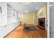 Inviting living room with hardwood floors, a brick fireplace, and custom built-in shelving at 893 Piedmont Ne Ave # 5, Atlanta, GA 30309