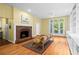 Stylish living room featuring a fireplace, built-in shelves, and a balcony with natural light at 893 Piedmont Ne Ave # 5, Atlanta, GA 30309