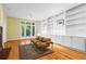 Spacious living room with built-in shelving, hardwood floors, and a cozy seating area at 893 Piedmont Ne Ave # 5, Atlanta, GA 30309