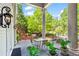Relaxing porch view with decorative lighting, potted plants, and serene green surroundings at 893 Piedmont Ne Ave # 5, Atlanta, GA 30309