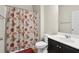 Bathroom featuring floral shower curtain, vanity with sink and a wall mirror at 115 Court Xing, Locust Grove, GA 30248