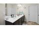 Bright bathroom featuring a double sink vanity with white countertop, multiple doors and neutral colors at 115 Court Xing, Locust Grove, GA 30248
