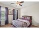 Bedroom featuring a bed, ceiling fan, and natural light from the windows at 115 Court Xing, Locust Grove, GA 30248