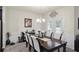 Elegant dining room featuring a dark wood table, upholstered chairs, and stylish decor at 115 Court Xing, Locust Grove, GA 30248