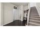Inviting entryway featuring hardwood floors, staircase, and coat rack at 115 Court Xing, Locust Grove, GA 30248