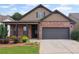 Charming brick and siding home with a covered front porch and attached two-car garage at 115 Court Xing, Locust Grove, GA 30248