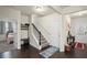 Bright foyer with hardwood floors, staircase, and views into a bedroom and additional room at 115 Court Xing, Locust Grove, GA 30248