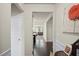 Hallway leading to living room, features dark wood floors, and light walls at 115 Court Xing, Locust Grove, GA 30248
