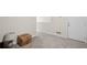 Hallway or unfinished basement featuring light walls, carpet, and a white door at 115 Court Xing, Locust Grove, GA 30248