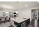 Kitchen island with granite countertops, stainless steel sink, and seating for three at 115 Court Xing, Locust Grove, GA 30248