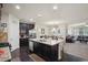 Open kitchen featuring granite countertops, stainless steel appliances, and a kitchen island with seating at 115 Court Xing, Locust Grove, GA 30248