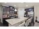 Modern kitchen with dark cabinets, stainless steel appliances, and a large kitchen island with seating at 115 Court Xing, Locust Grove, GA 30248