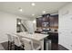 Modern kitchen island featuring granite countertops, stainless steel sink, and pendant lighting at 115 Court Xing, Locust Grove, GA 30248