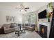 Comfortable living room with a fireplace, soft lighting, and stylish decor at 115 Court Xing, Locust Grove, GA 30248